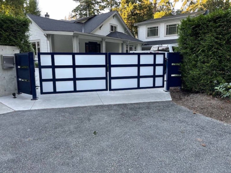 Modern swing driveway gate with frosted glass panels and a sleek dark metal frame.