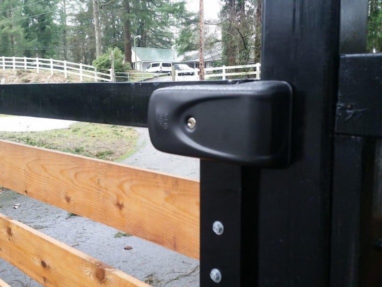 Wood and metal doorway gate featuring a secure latch mechanism.