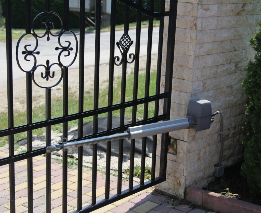 A metal gate with a sign on it, serving as an entrance or barrier. 